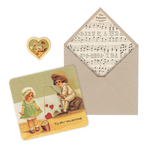Enjoy a touch of the past with our 1900s Vintage Beach-Fishing Valentine Card illustration and our hand-crafted 1900s music sheet paper envelope. Perfect way to share your love if you are fishin' for someone’s heart. Reproduced from vintage treasure printed in Germany around the 1900s.. Hand-crafted envelope created using a music sheet from "Siefert’s Choice Songs” printed in the 1900s. tribegift.com