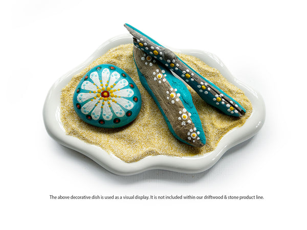Daisy patterning plus natural materials equals a touch of peace and love. Hippies considered flowers as a symbol of non-violence, pureness and harmony. Our hand-painted daisy-inspired driftwood and stone collection helps you bring a sense of hippie vibe into your home! Driftwood and stones have been hand-selected while walking the shoreline. Each piece is uniquely shaped and smoothed from the water and motion of waves have been washed, painted and sealed. tribegift.com