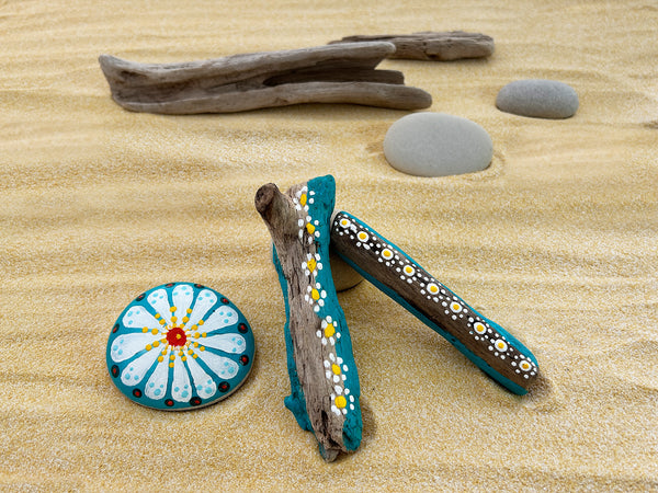 Daisy patterning plus natural materials equals a touch of peace and love. Hippies considered flowers as a symbol of non-violence, pureness and harmony. Our hand-painted daisy-inspired driftwood and stone collection helps you bring a sense of hippie vibe into your home! Driftwood and stones have been hand-selected while walking the shoreline. Each piece is uniquely shaped and smoothed from the water and motion of waves have been washed, painted and sealed. tribegift.com