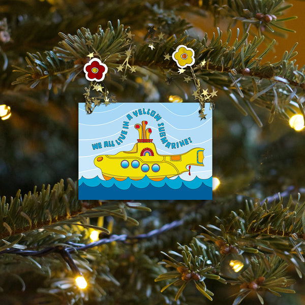 Colorful and sparkling Yellow Submarine Christmas ornament for you or your special someone! A Yellow Submarine sails the sea amid golden garland reflections. Unique one-of-a-kind ornament. Two flower heads accent a golden star-wired garland hoop affixed to the top and works perfect for hanging! Quantity pricing - 1 for 8.95, 4 for 6.74 each, and 8+ for 4.87 each. Great way to say "Merry Christmas" or "Happy Holidays" in Beatle language! tribegift.com