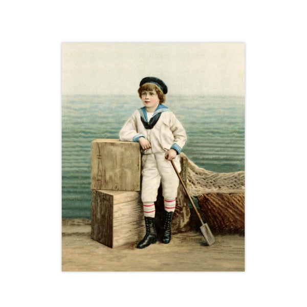 A young boy dressed in a sailor outfit and hat rests his right elbow on seaside crates and holds an oar in his left hand. This Antique Trading Card print presents soft seaside colors with rippling ocean waves in the background. His black shoes with striped socks certainly creates a confident seaside pose! Vintage print reproduction measures 8 x 10 inches. Printed on durable cover stock with soft velvet finish. tribegift.com
