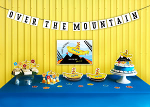 A bold and brave Yellow Submarine makes its way over the peak of a mountain within this party pack theme.  This is no average “Over the Hill” experience. We are talking mountains - not hills. Enjoy celebrating getting old Beatle style! Party Pack includes pennant banner, poster, cut-out décor, cake topper and food picks. - tribegift.com